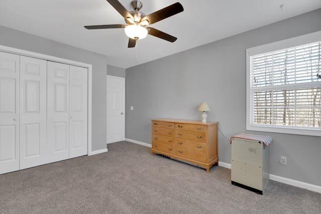 unfurnished bedroom featuring a closet, light colored carpet, and ceiling fan