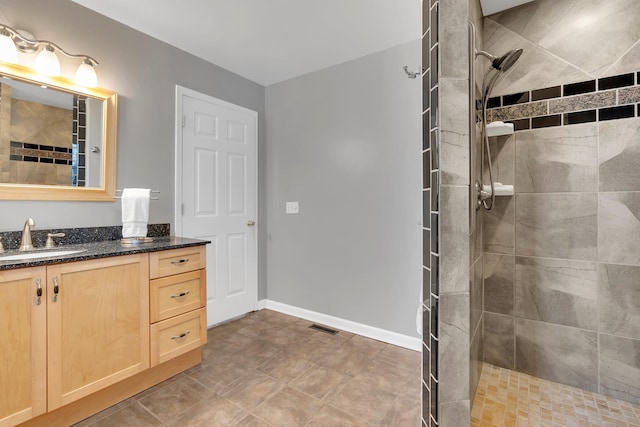 bathroom featuring vanity and a tile shower