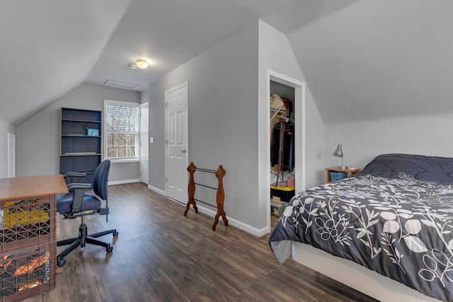 bedroom with vaulted ceiling and dark hardwood / wood-style flooring