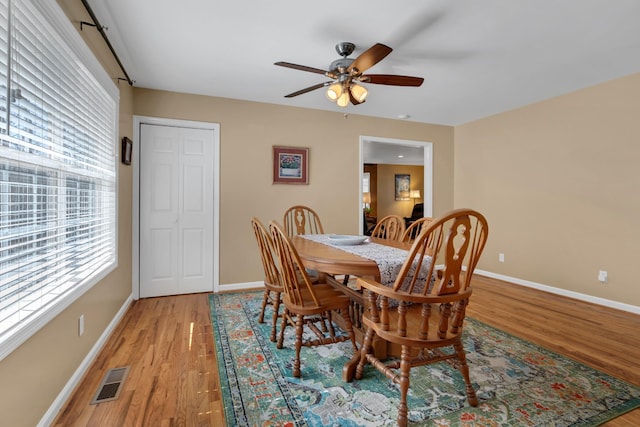 dining area with ceiling fan and light wood-type flooring