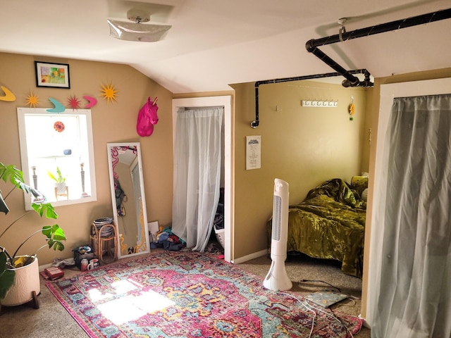 bedroom featuring vaulted ceiling and carpet