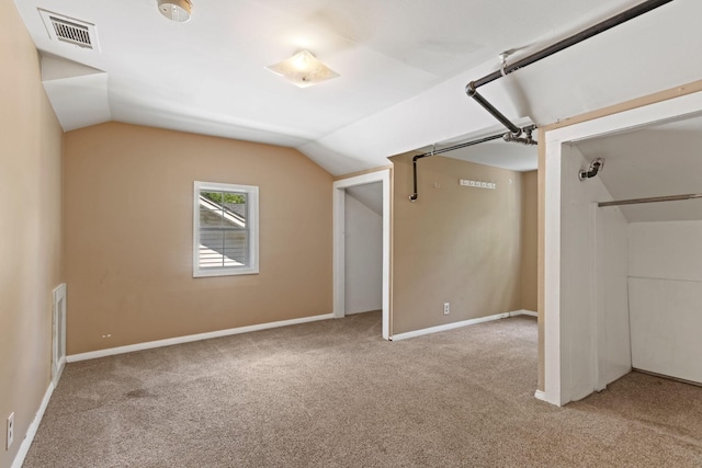 additional living space with vaulted ceiling and light colored carpet