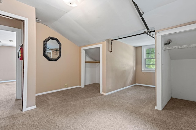 interior space featuring vaulted ceiling and carpet floors