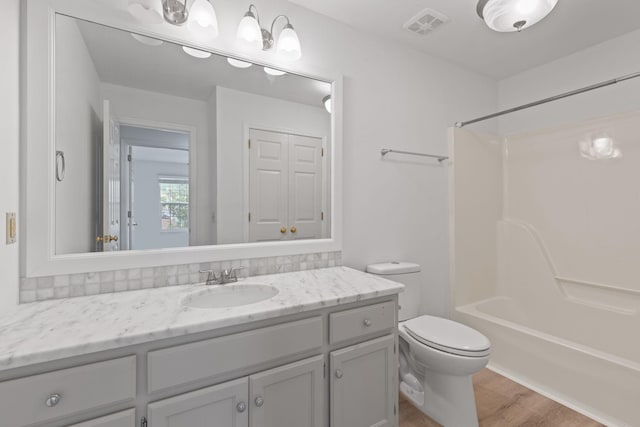 474 S Main St Unit 203, Ashland City, TN 37015 - full bathroom featuring hardwood / wood-style flooring, vanity, washtub / shower combination, and toilet