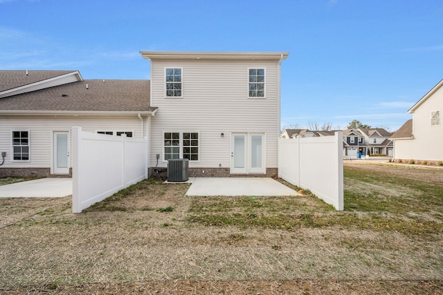 back of house with fence, a lawn, and a patio