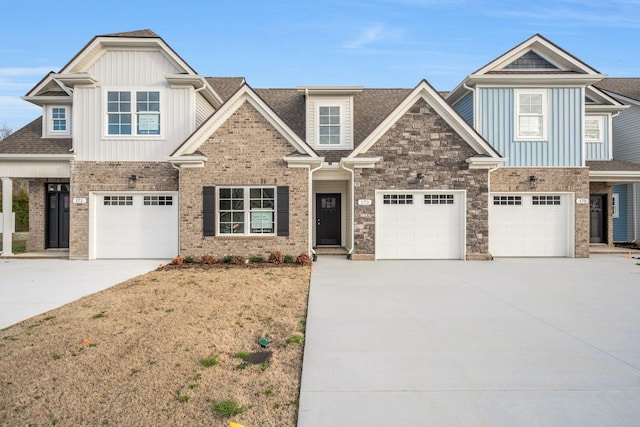 craftsman inspired home featuring driveway, board and batten siding, stone siding, and roof with shingles