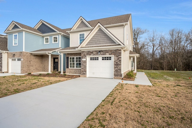 view of front of property featuring concrete driveway, stone siding, roof with shingles, an attached garage, and a front lawn