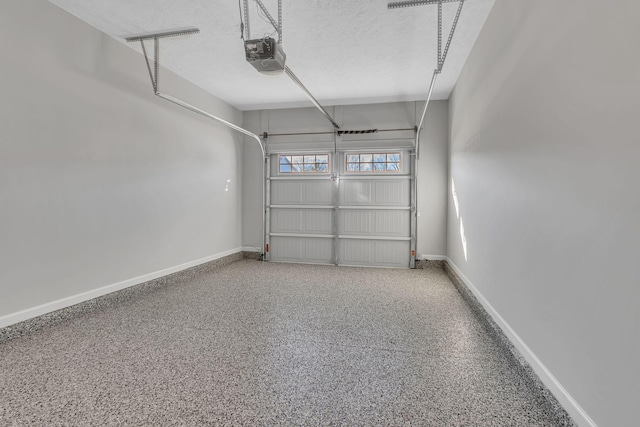 garage with a garage door opener and baseboards