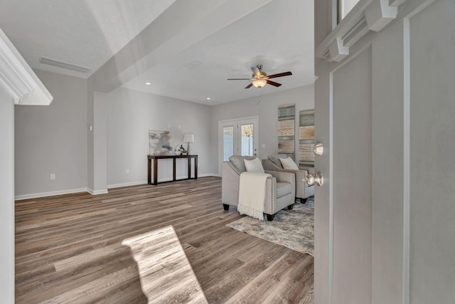 living room with visible vents, baseboards, ceiling fan, wood finished floors, and french doors