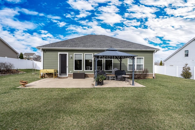 back of property featuring a gazebo, a yard, and a patio