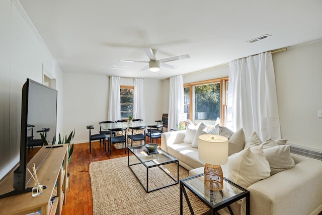 living room with ceiling fan and dark hardwood / wood-style flooring