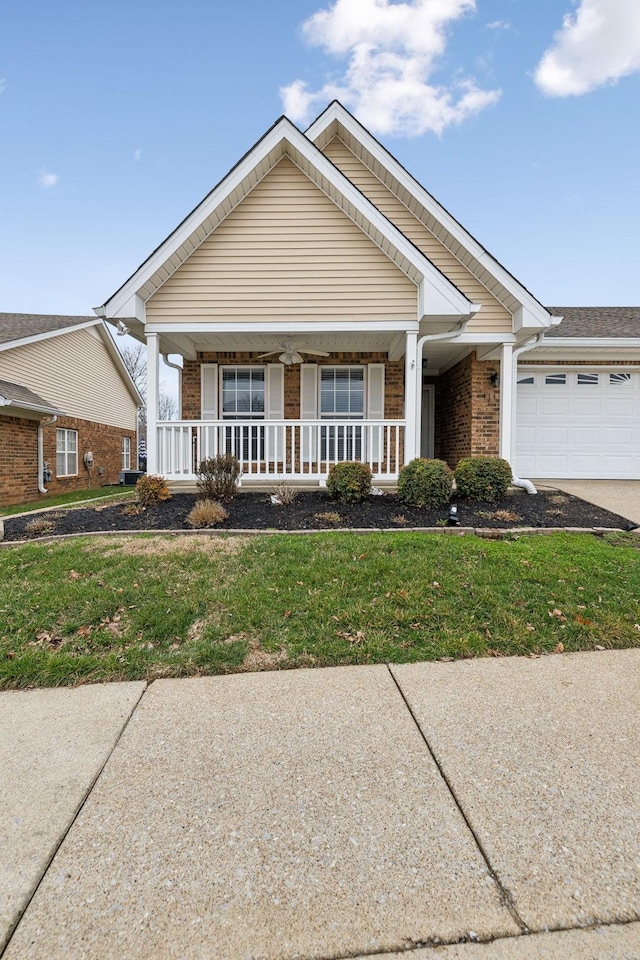 view of front facade featuring a garage, a front yard, and covered porch