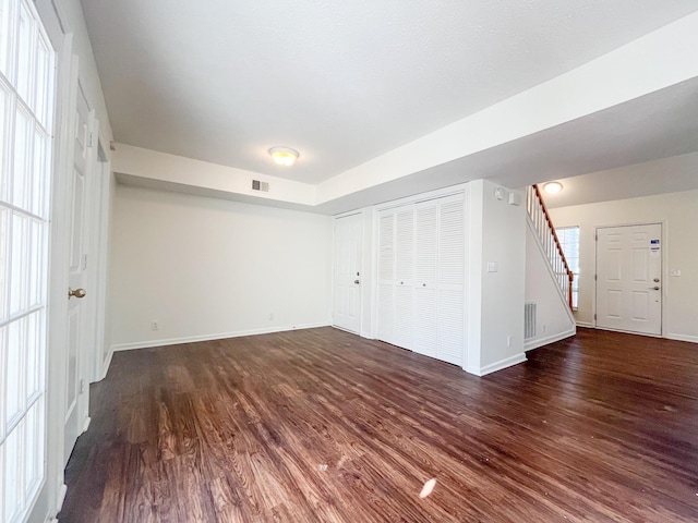 unfurnished bedroom with dark hardwood / wood-style floors