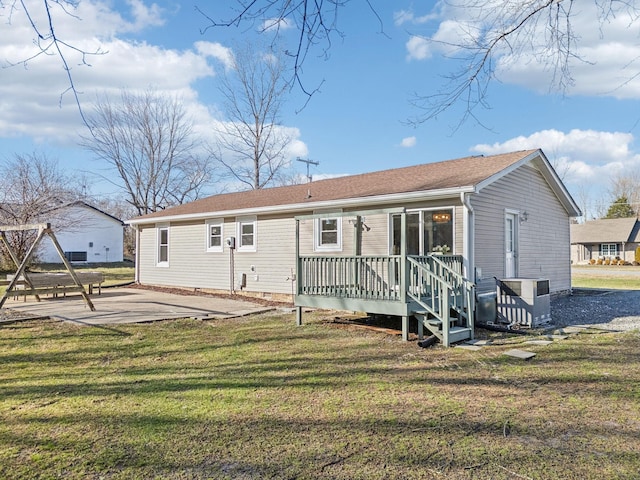 rear view of house with crawl space, a yard, and a patio