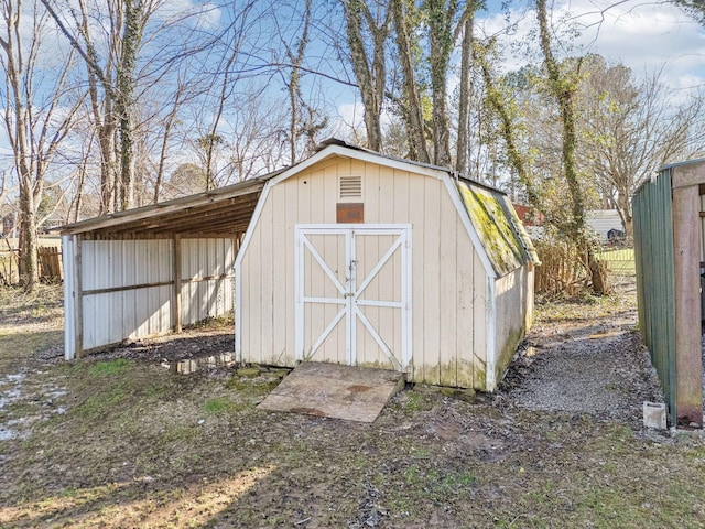 view of shed featuring fence
