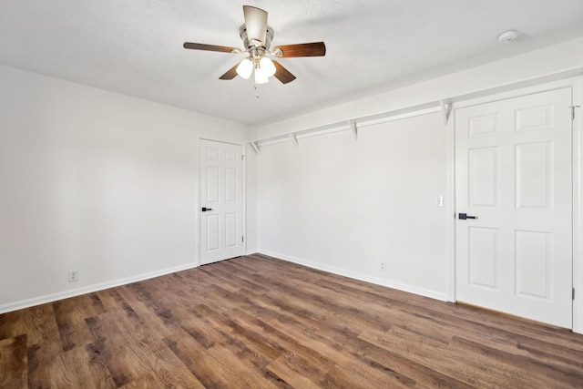 unfurnished bedroom with a ceiling fan, dark wood finished floors, and baseboards