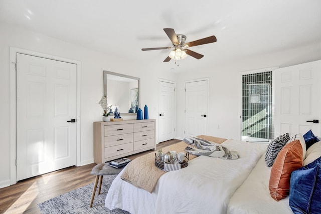 bedroom with access to exterior, baseboards, a ceiling fan, and wood finished floors