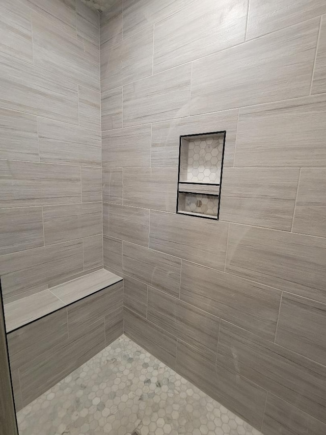 bathroom with a tile shower