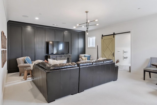 carpeted living room featuring a barn door and a notable chandelier