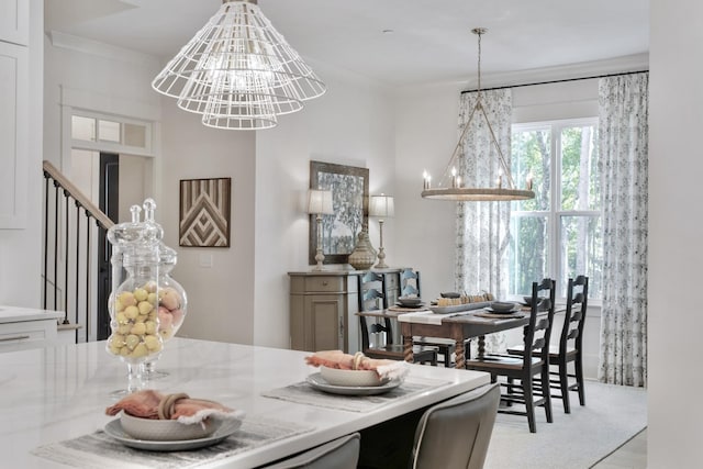 dining space with crown molding and a notable chandelier