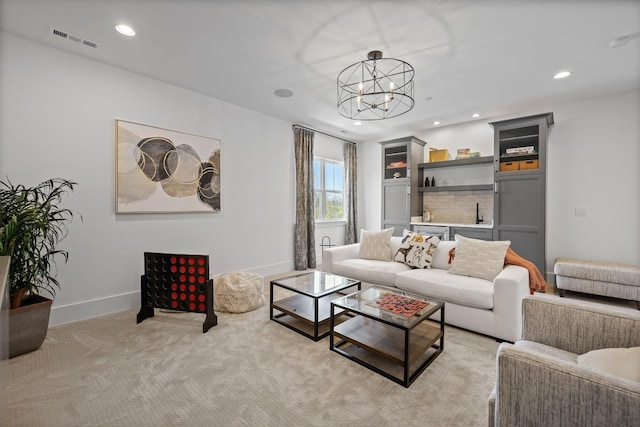 living room featuring light carpet and a chandelier