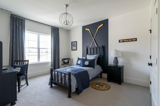 bedroom with light carpet and a notable chandelier