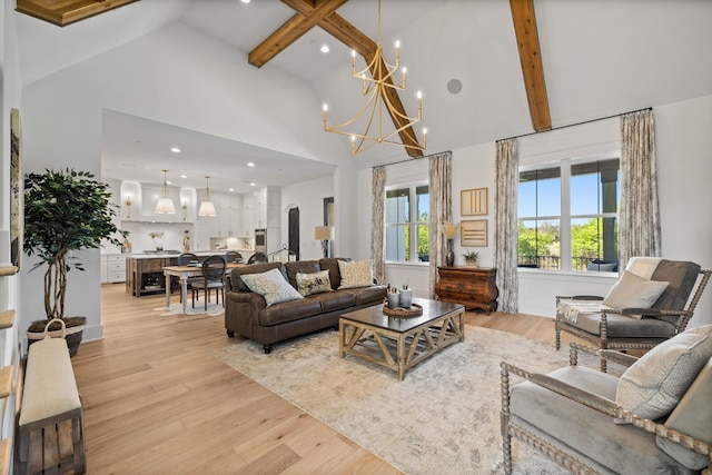 living room featuring high vaulted ceiling, light hardwood / wood-style floors, and beamed ceiling