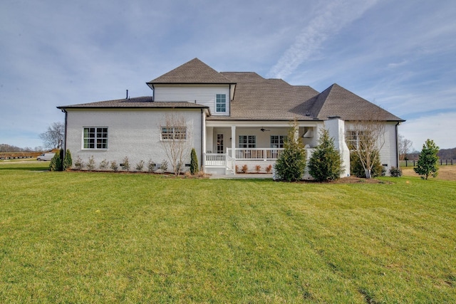 rear view of house with a yard and covered porch