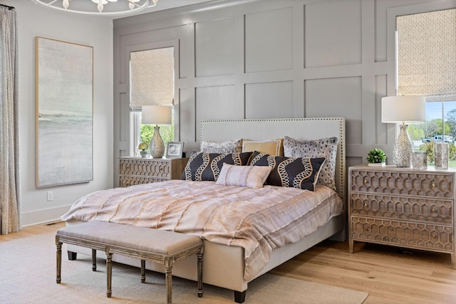 bedroom featuring multiple windows and light hardwood / wood-style floors