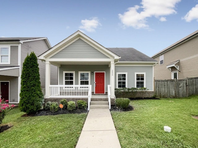 view of front of property featuring covered porch and a front lawn