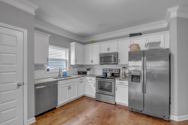 kitchen featuring sink, white cabinets, and appliances with stainless steel finishes