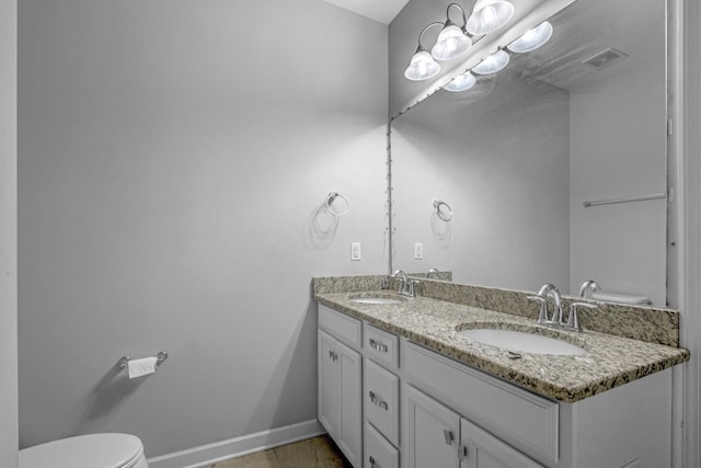 bathroom featuring tile patterned flooring, vanity, and toilet