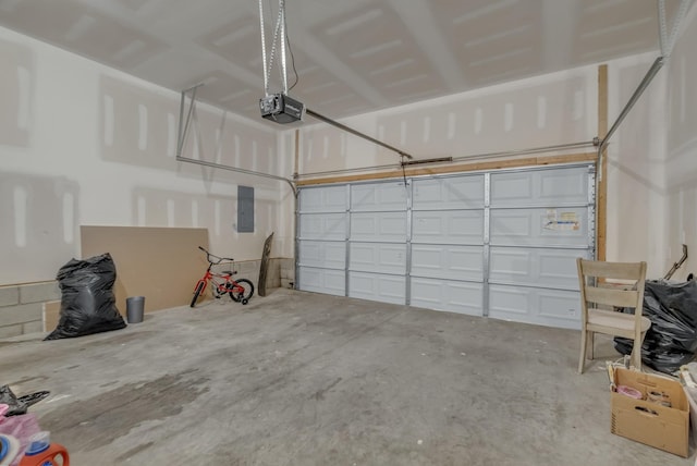 garage with a garage door opener and electric panel