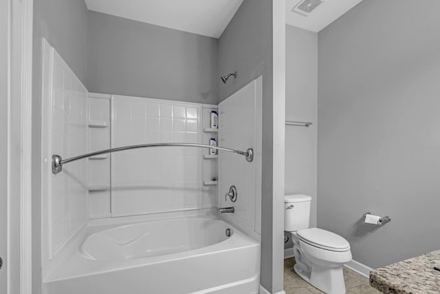 bathroom with tile patterned floors, tub / shower combination, and toilet