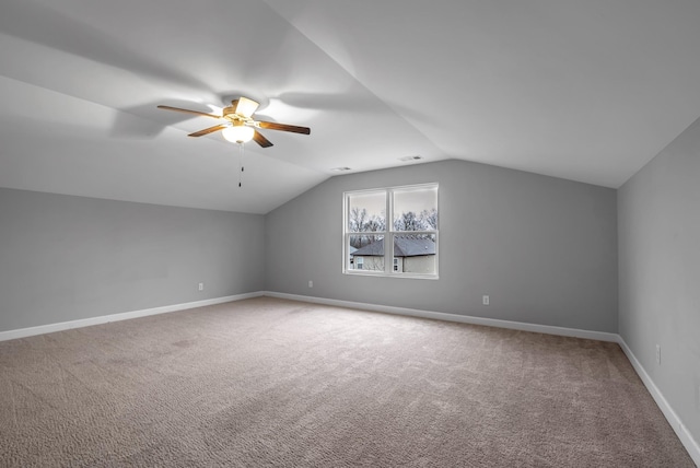 additional living space with ceiling fan, lofted ceiling, and carpet floors