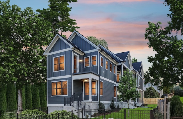 view of front of home with board and batten siding and a fenced front yard