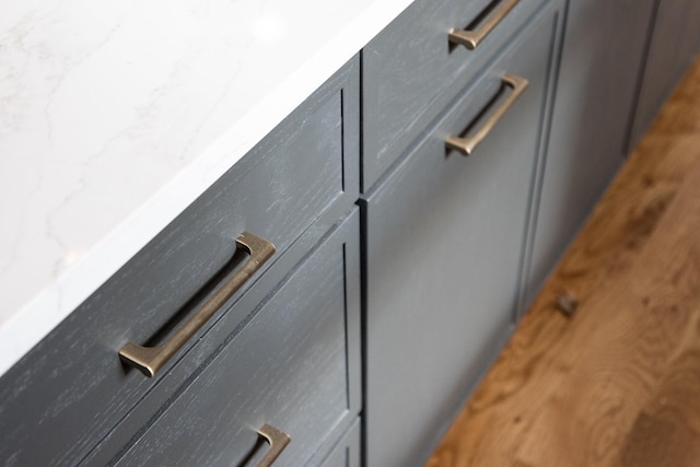 interior details featuring stone countertops and gray cabinetry