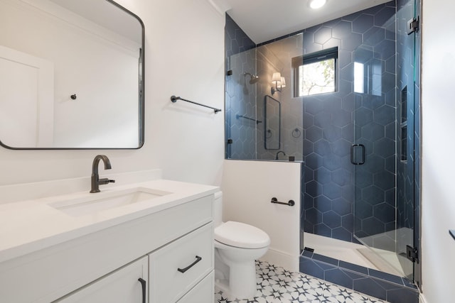 bathroom featuring a shower stall, toilet, and vanity