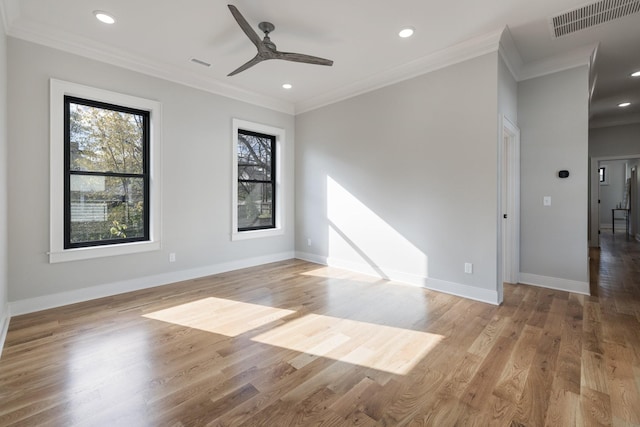 spare room with baseboards, visible vents, ornamental molding, light wood-type flooring, and recessed lighting