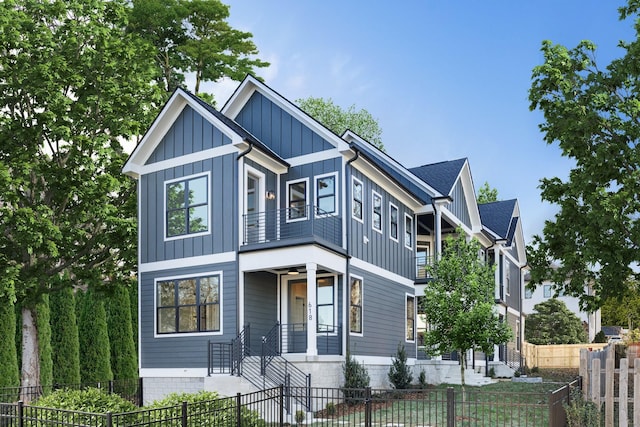 view of front of house with board and batten siding and a fenced front yard