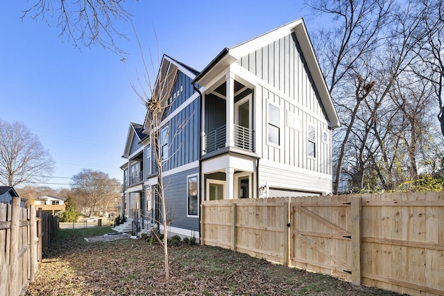 view of home's exterior featuring board and batten siding and fence