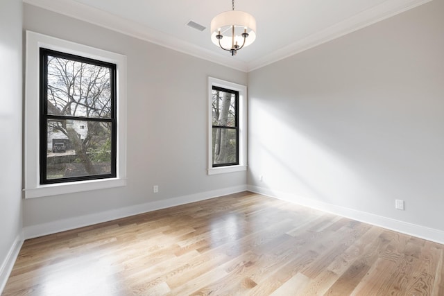 unfurnished room featuring a notable chandelier, visible vents, baseboards, light wood-style floors, and crown molding