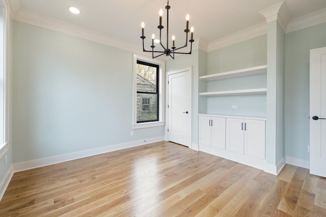 unfurnished dining area with baseboards, built in shelves, light wood-type flooring, and crown molding