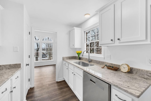 kitchen with dark wood-type flooring, sink, dishwasher, light stone countertops, and white cabinets