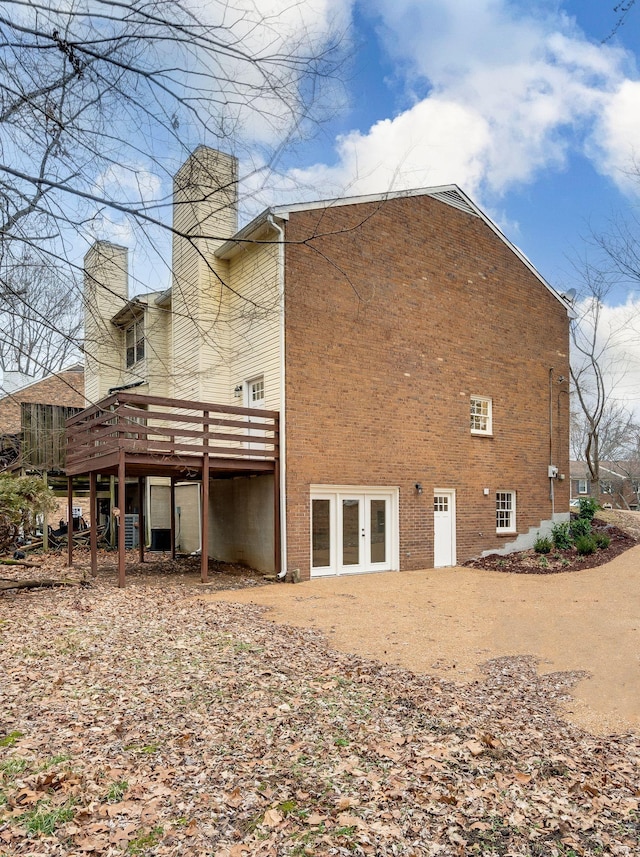 rear view of property featuring french doors and a deck