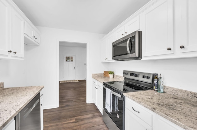 kitchen with appliances with stainless steel finishes, light stone countertops, and white cabinets