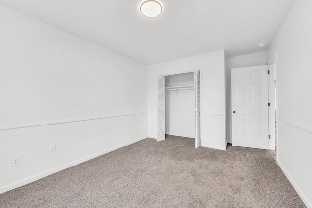 unfurnished bedroom featuring carpet floors and a closet