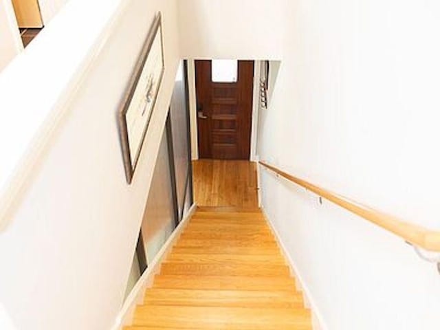 stairway featuring wood-type flooring