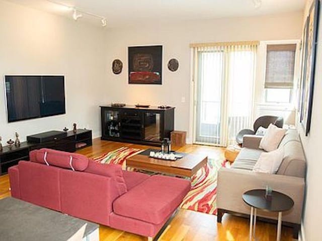 living room featuring hardwood / wood-style flooring and track lighting