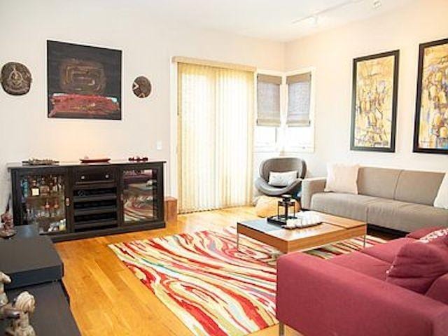 living room featuring rail lighting and hardwood / wood-style floors